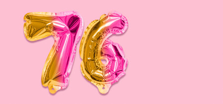 Rainbow foil balloon number, digit seventy six on a pink background. Birthday greeting card with inscription 76. Top view. Numerical digit. Celebration event template. Banner.の写真素材