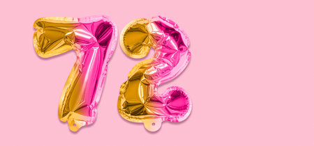 Rainbow foil balloon number, digit seventy two on a pink background. Birthday greeting card with inscription 72. Top view. Numerical digit. Celebration event template. Banner.の写真素材