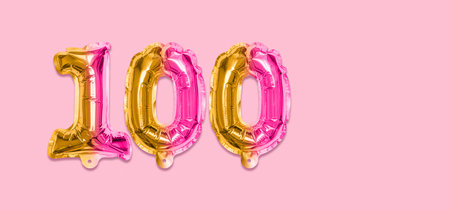 Rainbow foil balloon number, digit one hundred on a pink background. Birthday greeting card with inscription 100. Anniversary concept. Numerical digit. Celebration event template. Banner.の写真素材