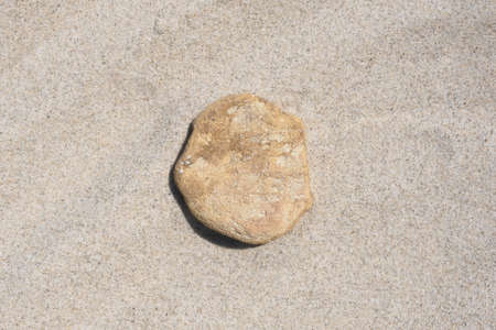 Podium made of natural stone on a natural background of sand. Showcase for product promotion, beauty, natural eco cosmetic. copyspace. top view.の写真素材