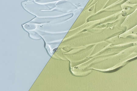 Transparent hyaluronic acid or serum gel. Textured background with oxygen bubbles on a gray and...