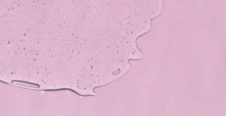 Transparent hyaluronic gel or serum on a pink background. skincare cosmetics product. wellness and beauty concept. top view.の写真素材