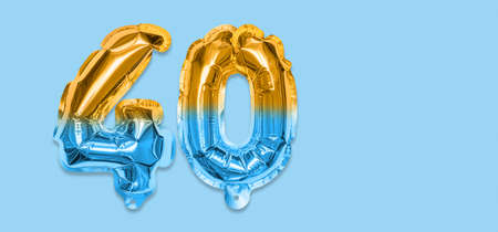 Rainbow foil balloon number, digit forty on a blue background. Birthday greeting card with inscription 40. Anniversary concept. top view. Numerical digit. Celebration event template. Bannerの写真素材
