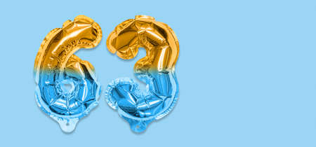 Rainbow foil balloon number, digit sixty three on a blue background. Birthday greeting card with inscription 63. Top view. Numerical digit. Celebration event template. Bannerの写真素材