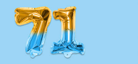 Rainbow foil balloon number, digit seventy one on a blue background. Birthday greeting card with inscription 71. Top view. Numerical digit. Celebration event template. Bannerの写真素材