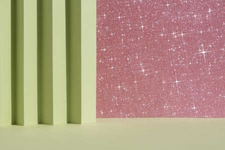 Abstract geometric green and pink shiny sparkling background for the presentation of a cosmetic product or gift. Premium podium scene. Showcase, display case.の写真素材