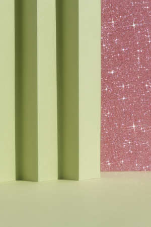 Abstract geometric green and pink shiny sparkling background for the presentation of a cosmetic product or gift. Premium podium scene. Showcase, display case.の写真素材