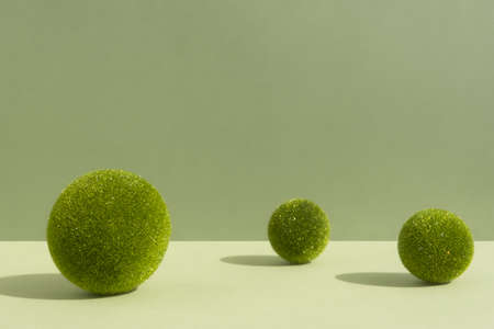 Minimal abstract scene with grass balls on a green background for the presentation of a cosmetic product. Premium podium for product promotion, beauty, natural eco cosmetic. Showcase, display case.の写真素材