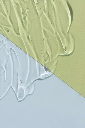 Transparent hyaluronic acid or serum gel. Textured background with oxygen bubbles on a gray and green background. The concept of cosmetics.の写真素材