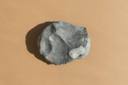 Podium made of natural gray stone on a beige background. Scene for product promotion, beauty, natural eco cosmetic. Showcase, display case.の写真素材
