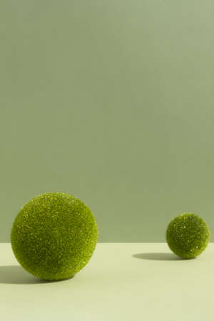 Minimal abstract scene with grass balls on a green background for the presentation of a cosmetic product. Premium podium for product promotion, beauty, natural eco cosmetic. Showcase, display case.の写真素材