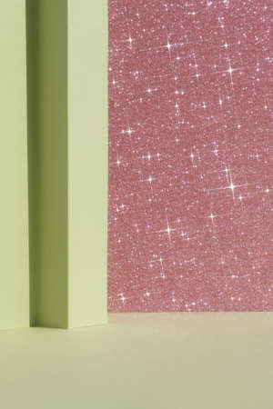 Abstract geometric green and pink shiny sparkling background for the presentation of a cosmetic product or gift. Premium podium scene. Showcase, display case.の写真素材