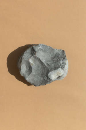 Podium made of natural gray stone on a beige background. Scene for product promotion, beauty, natural eco cosmetic. Showcase, display case.の写真素材