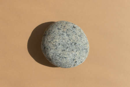 Podium made of natural gray stone on a beige background. Scene for product promotion, beauty, natural eco cosmetic. Showcase, display case. top viewの写真素材
