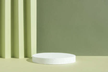 Abstract empty white podium on a green background. A scene with a geometric background. Backdrop for the product presentation.の写真素材