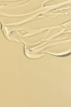 Transparent serum gel with hyaluronic acid for the face on a beige background. The texture of a cosmetic product with oxygen bubbles. wellness and beauty concept.の写真素材