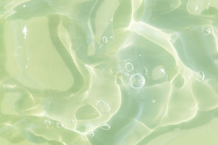 The texture of a green gel or serum with hyaluronic acid for the face. Cosmetic transparent liquid cream with oxygen bubbles. wellness and beauty concept. Sanitizer, virus protection.の写真素材