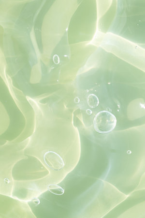 The texture of a green gel or serum with hyaluronic acid for the face. Cosmetic transparent liquid cream with oxygen bubbles. wellness and beauty concept. Sanitizer, virus protection.の写真素材