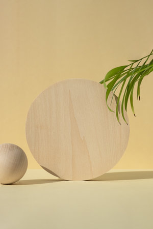 Wooden podiums, pedestals on a beige background with palm leaves. Showcases for the promotion of products, beauty, natural cosmetics. Abstract minimalistic elegant studio stage.の写真素材