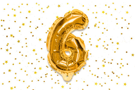 The number of the balloon made of golden foil, the number six on a white background with sequins. Birthday greeting card with inscription 6. Numerical digit, Celebration event, template.の写真素材