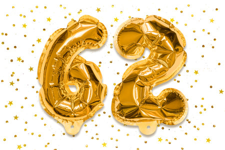 The number of the balloon made of golden foil, the number sixty two on a white background with sequins. Birthday greeting card with inscription 62. Numerical digit, Celebration event.の写真素材
