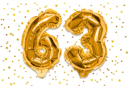 The number of the balloon made of golden foil, the number sixty three on a white background with sequins. Birthday greeting card with inscription 63. Numerical digit, Celebration event.の写真素材