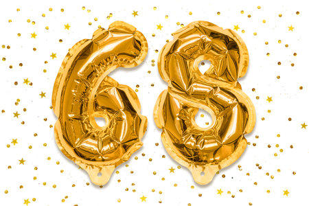 The number of the balloon made of golden foil, the number sixty eight on a white background with sequins. Birthday greeting card with inscription 68. Numerical digit, Celebration event.の写真素材