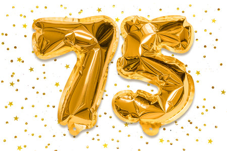The number of the balloon made of golden foil, the number seventy five on a white background with sequins. Birthday greeting card with inscription 75. Anniversary concept.の写真素材
