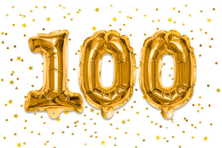 The number of the balloon made of golden foil, the number one hundred on a white background with sequins. Birthday greeting card with inscription 100. Anniversary concept.の写真素材