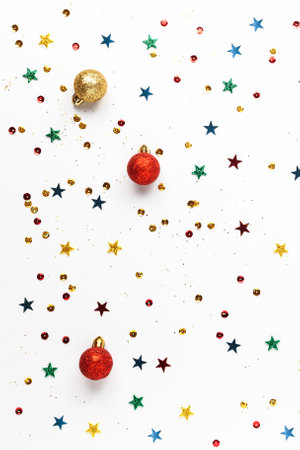 Festive Christmas gold, red decorations, multicolored sequins on a white background. Festive New Year sparkling texture, postcard.の写真素材