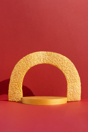 Geometric golden podium on an abstract red background. Scene for the product presentation. Showcase, display case.の写真素材