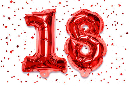 The number of the balloon made of red foil, the number eighteen on a white background with sequins. Birthday greeting card with inscription 18. Numerical digit, Celebration event.の写真素材