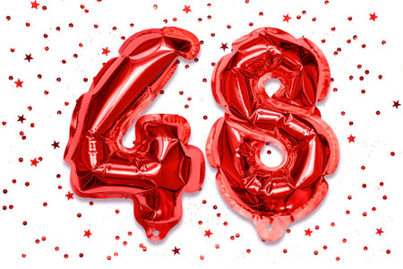 The number of the balloon made of red foil, the number forty-eight on a white background with sequins. Birthday greeting card with inscription 48. Numerical digit. celebration event.の写真素材