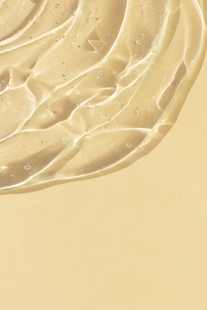 Transparent serum gel with hyaluronic acid for the face on a beige background. The texture of a cosmetic product with oxygen bubbles. wellness and beauty conceptの写真素材
