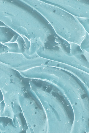 Transparent serum gel with hyaluronic acid for the face on a blue background. The texture of a cosmetic product with oxygen bubbles. wellness and beauty concept.の写真素材