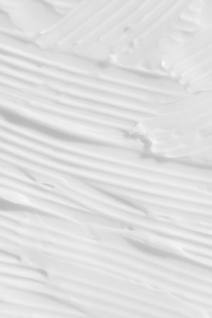 The texture of the white cream. cosmetic background. Smears of body care cosmetics. wellness and beauty concept. top view.の写真素材