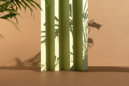 Abstract beige and green background with shadow of palm leaves for the presentation of a cosmetic product. A scene with a geometric backdrop. Podium for product promotion, beauty, natural eco cosmeticの写真素材