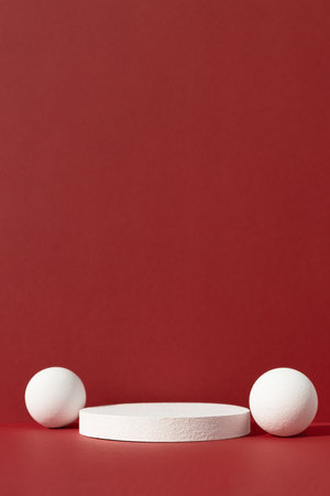 Geometric white podium with balls on an abstract red background. Empty scene for the product presentation. Showcase, display case.の写真素材