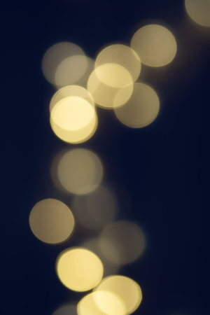 Golden abstract bokeh on a dark blue background. The concept of the holiday. Christmas, New Year...