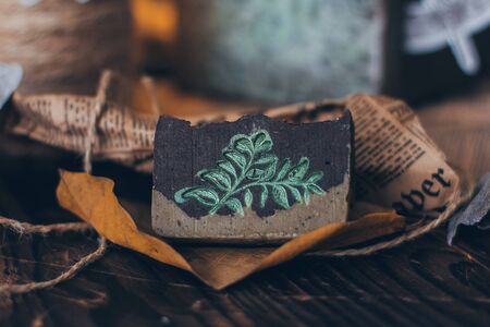 Beautiful natural handcrafted soap on wooden background with botanical, close up. For relax, health,...