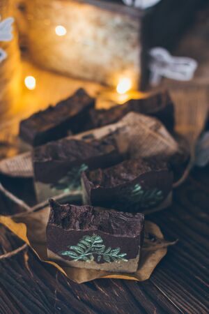 Beautiful natural handcrafted soap on wooden background with botanicals, close up. For relax, health, spa, aromatherapy.の写真素材