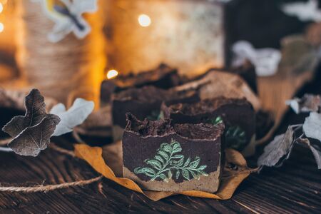 Beautiful natural handcrafted soap on wooden background with botanicals, close up. For relax, health, spa, aromatherapy.の写真素材
