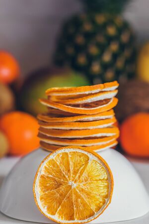 Dried homemade healthy fresh dehydrated slices of fruits. Fruit chips, natural raw vegan organic snack. Healthy food concept. Orange.の写真素材