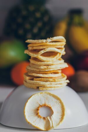 Dried homemade healthy fresh dehydrated slices of fruits. Fruit chips, natural raw vegan organic snack. Healthy food concept. Apple.の写真素材
