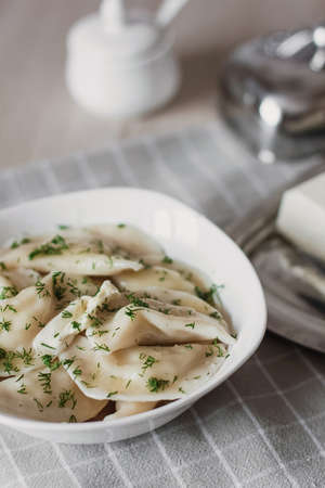 Dumplings, filled with potatoes and served with butter and fennel. Varenyky, vareniki, pierogi,...