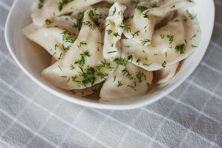 Dumplings, filled with potatoes and served with butter and fennel. Varenyky, vareniki, pierogi, pyrohy. Dumplings with fillingの写真素材