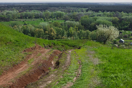 Spring countryside view with road, cherry blossom blooming villages, hills. Ukraine.の写真素材