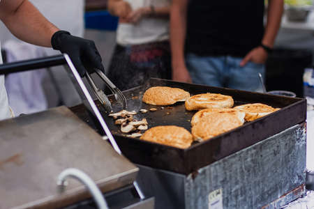 People cooking food on the streets with minimum protection. Take away meal concept, express food serviceの写真素材