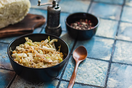 Salad with cabbage, eggs, corns and meat on the plate on rustic tiled table.の写真素材