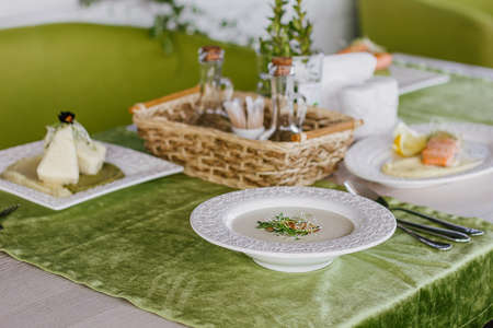 Cheese soup with salmon in green interior background.の写真素材